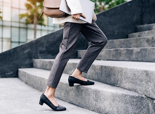 Business woman walking up steps